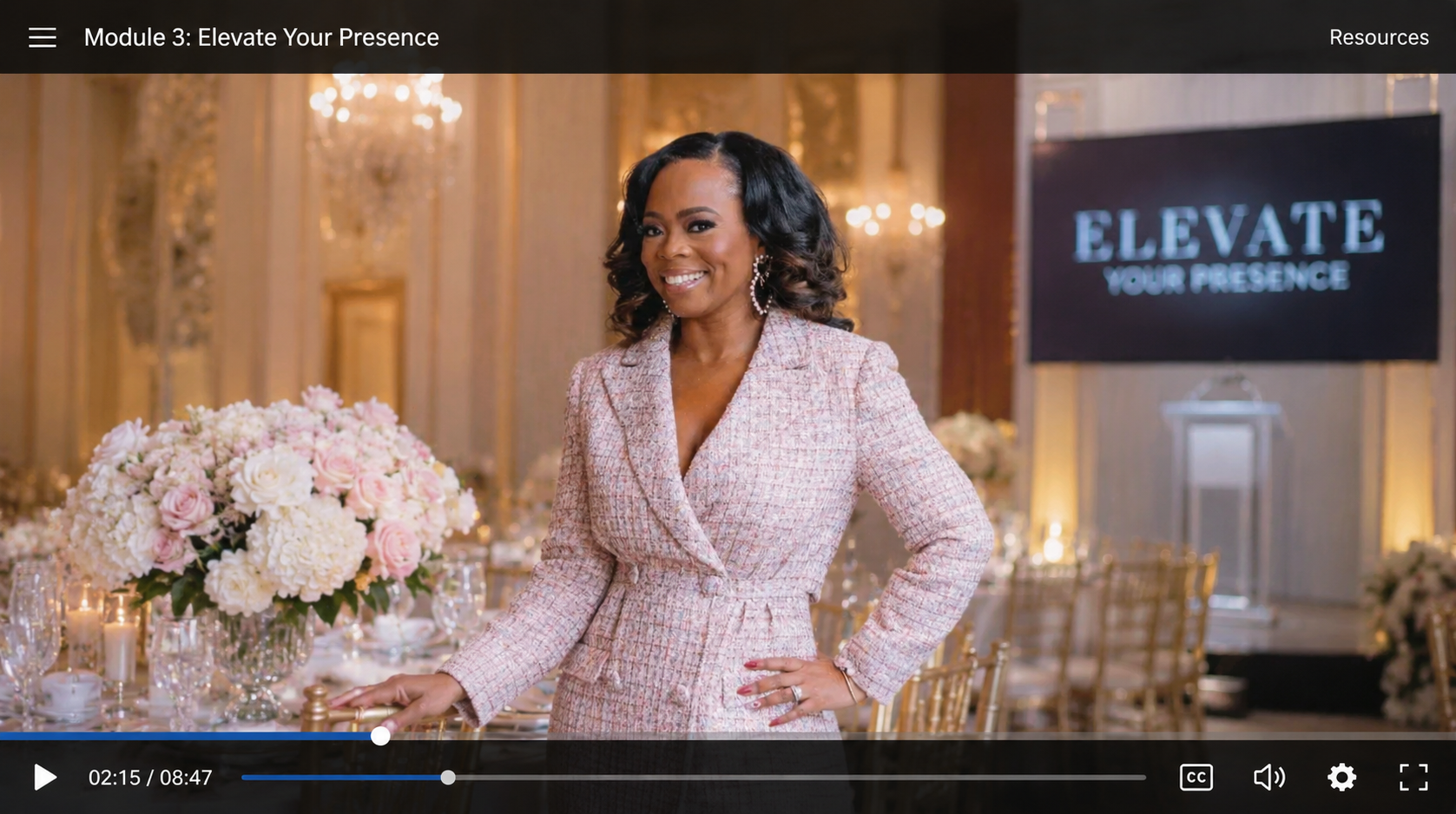 Michelle Gainey presenting a course module in a luxury ballroom